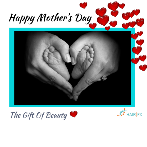 Black & White image of mother holding baby's feet forming a heart shape